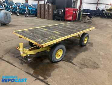 Metal frame industrial cart with one steerable axle 4’W x 9’L, pivot ring bar on the steer axle...