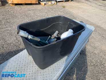 Bin of various items including sunnyside deck wash, a bench vise, and more