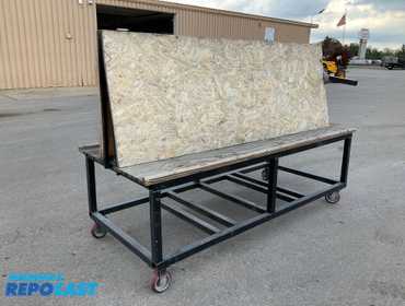 Metal frame work bench on casters 96” x 40” x 31”T at the table, plywood table top, has a tilted...