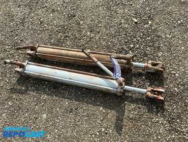 (2) Used Matching Hydraulic Cylinders, approx. 1” diameter pins, approx. 38” eye to eye as pictured