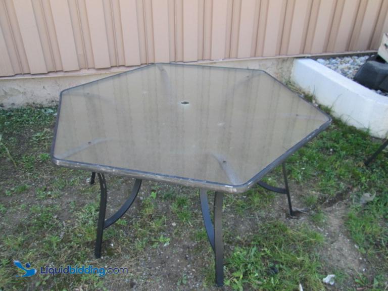 Hexagon glass patio table. Used. 62" wide at widest point.